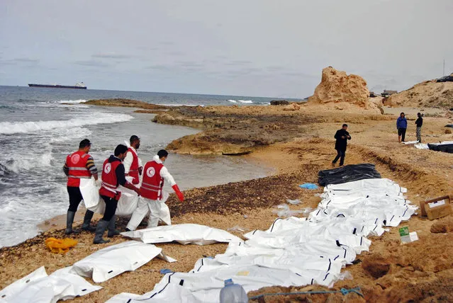 This Monday, February 20, 2017 photo provided by The International Federation of Red Cross and Red Crescent Societies (IFRC), shows the bodies of people that washed ashore and were recovered by the Libyan Red Crescent, near Zawiya, Libya. The Libyan Red Crescent says at least 74 bodies of African migrants have washed ashore in western Libya, the latest tragedy at sea along a perilous trafficking route to Europe. It says the bodies were found on Monday, and that more may yet surface. (Photo by Mohannad Karima/IFRC via AP Photo)