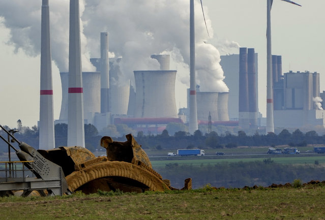 Steam comes out of the chimneys of the coal-fired power station Neurath near the Garzweiler open-cast coal mine in Luetzerath, Germany, Monday, October 25, 2021. The climate change conference COP26 will start next Sunday in Glasgow, Scotland. (Photo by Michael Probst/AP Photo)