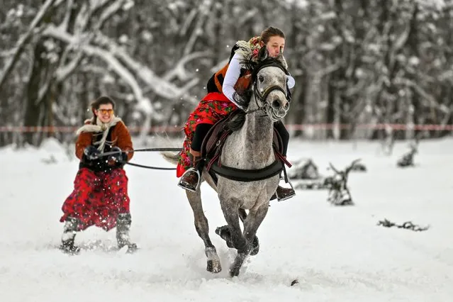 A competitor is seen in action in the ski-skiring category (skier behind a horse with rider category), during the 2023 edition of Kumoterki in Bialy Dunajec, Poland on January 22, 2023. Every year, depending on the weather, several “Kumoterki” competitions are held in the vicinity of Zakopane. In 2017, Kumoterki races were entered on the National List of Intangible Cultural Heritage. (Photo by Artur Widak/Anadolu Agency via Getty Images)