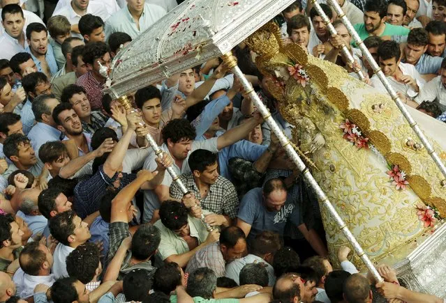 The Virgin of El Rocio is carried by pilgrims during a procession around the shrine of El Rocio in Almonte, southern Spain, May 25, 2015. (Photo by Marcelo del Pozo/Reuters)