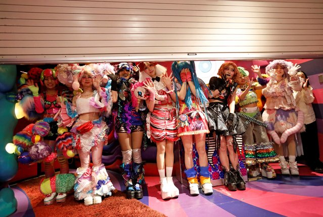Staff members of Kawaii Monster Cafe called “Monster Girls” wave and bow to guests while the entrance shutter gate goes down as the cafe ends its five-year run operation on the day, amid the coronavirus disease (COVID-19) outbreak, in Tokyo,  Japan on January 31, 2021. (Photo by Issei Kato/Reuters)