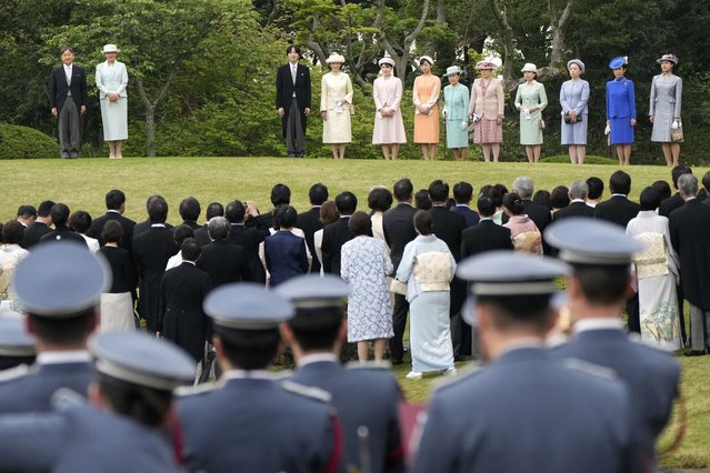 Japan's Emperor Naruhito, left, Empress Masako, second left, and other royal family members walk down a hill to greet guests during the spring garden party at the Akasaka Palace imperial garden Tuesday, April 23, 2024, in Tokyo. (Photo by Eugene Hoshiko/AP Photo)