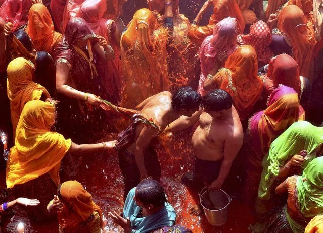Devotees playing Huranga at Dauji temple near Mathura on Tuesday, March 14, 2017, a day after Holi in which women tear the shirts of men. (Photo by Press Trust of India)