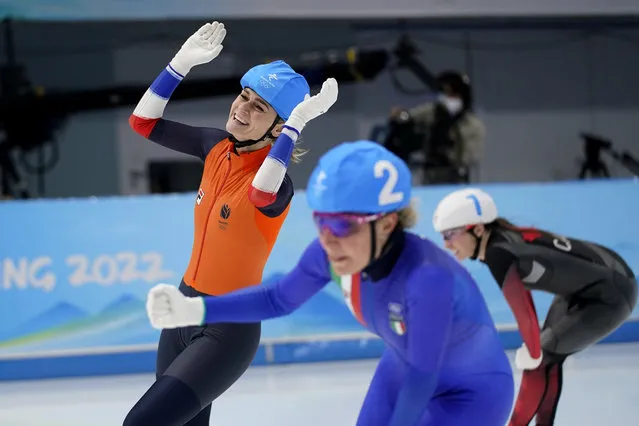 Irene Schouten of the Netherlands reacts after winning the gold medal ahead of Ivanie Blondin of Canada, right, who won silver, and Francesca Lollobrigida of Italy, foreground, who won bronze, during the women's speedskating mass start finals at the 2022 Winter Olympics, Saturday, February 19, 2022, in Beijing. (Photo by Ashley Landis/AP Photo)