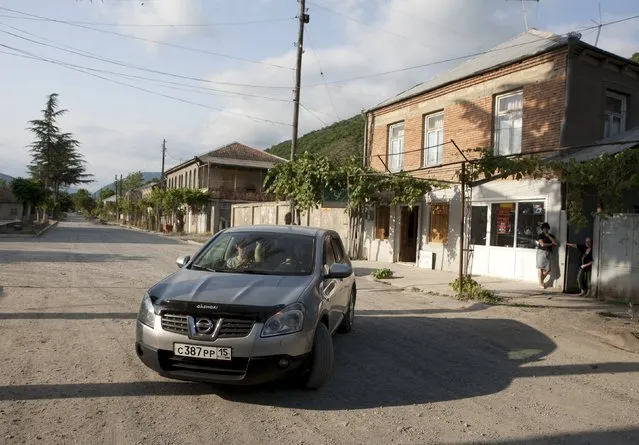 People drive a car in a street of Leningori (or Akhalgori), in the breakaway region of South Ossetia, Georgia, July 6, 2015. (Photo by Kazbek Basaev/Reuters)