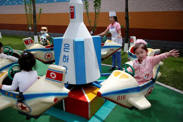Children enjoy a rocked themed merry-go-around during government organised visit for foreign reporters to the Kim Jong Suk Pyongyang textile mill in Pyongyang, North Korea May 9, 2016. (Photo by Damir Sagolj/Reuters)