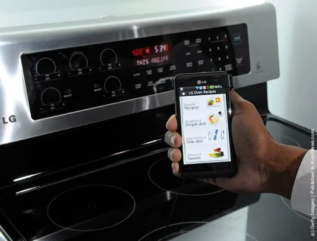 A smartphone sending instructions to an oven using LG's newest Smart ThinQ technology is demonstrated at the LG Electronics booth at the 2012 International Consumer Electronics Show