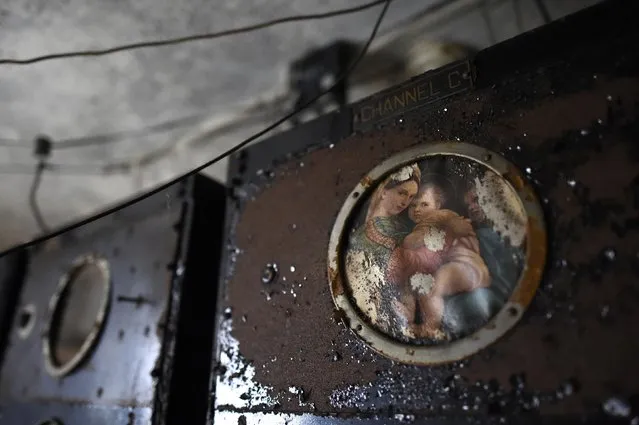 A painting of the Virgin Mary and child remains in the radio room of the now-closed Eastern State Penitentiary in Philadelphia, Pennsylvania April 30, 2014. (Photo by Mark Makela/Reuters)