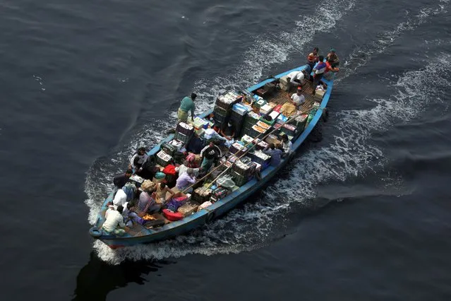 Vegetables are transported by a motorboat through the pitch-black water of the Buriganga River in Bangladesh on January 30, 2022. Millions of cubic meters of toxic waste from the tanneries and thousands of other industries, topped with a huge volume of untreated sewage from Dhaka City made water pollution in rivers reach alarming levels. (Photo by Habibur Rahman/ZUMA Press Wire Service/Rex Features/Shutterstock)