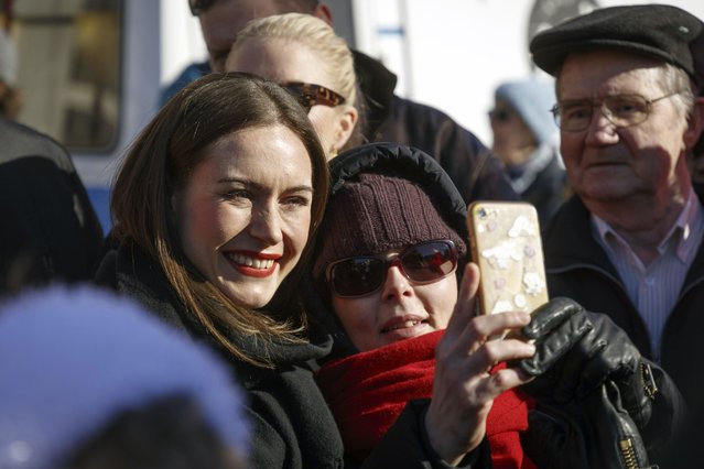 Finnish Prime Minister and chairperson of the Social Democratic Party (SDP) Sanna Marin poses for a selfie during a campaign event at the Tammela market square, in her hometown Tampere, Finland, April 1, 2023, ahead of the parliamentary elections day on Sunday, 2nd of April. (Photo by Kalle Parkkinen/Lehtikuva via AP Photo)