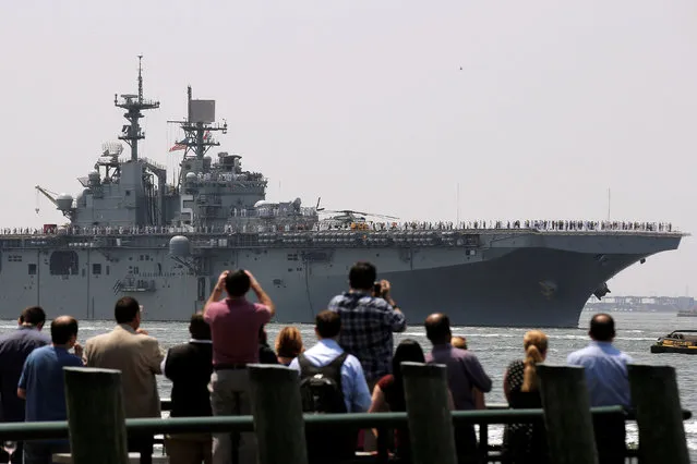 People watch as the wasp-class amphibious assault ship USS Bataan arrives in New York Harbor to mark the beginning of Fleet Week in New York City, U.S., May 25, 2016. (Photo by Brendan McDermid/Reuters)