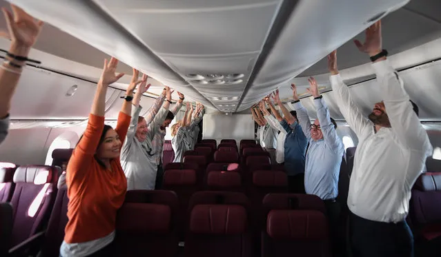 Passengers onboard QF7879 are taken through exercise classes during the flight from London to Sydney direct on November 15, 2019 in Sydney, Australia. The flight was restricted to 50 people, including 10 crew, to increase aircraft range, and included medical scientists and health experts on board to conduct studies in the cockpit and the cabin to help determine strategies to promote long haul inflight health and wellbeing on ultra-long haul flights. It comes as the national carrier continues to work towards the final frontier of global aviation by launching non-stop commercial flights between the US and the UK to the east coast of Australia in an ambitious project dubbed “Project Sunrise”. (Photo by James D. Morgan/Getty Images for Qantas)