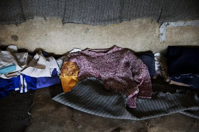 Children's clothes lie on a sofa in an empty house in the abandoned fishing village of Houtouwan on the island of Shengshan July 26, 2015. (Photo by Damir Sagolj/Reuters)