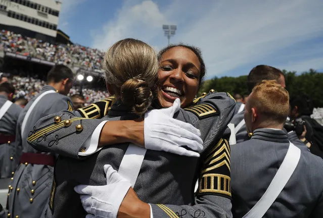 United States Military Academy cadets hug after graduating, Saturday, May 27, 2017, in West Point, N.Y. Nine Hundred and thirty six cadets received their diplomas, most of whom will be commissioned as second lieutenants in the army. (Photo by Julie Jacobson/AP Photo)