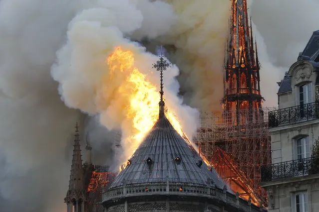 Flames burn the roof of the landmark Notre-Dame Cathedral in central Paris on April 15, 2019, potentially involving renovation works being carried out at the site, the fire service said. A major fire broke out at the landmark Notre-Dame Cathedral in central Paris sending flames and huge clouds of grey smoke billowing into the sky, the fire service said. The flames and smoke plumed from the spire and roof of the gothic cathedral, visited by millions of people a year, where renovations are currently underway. (Photo by Francois Guillot/AFP Photo)