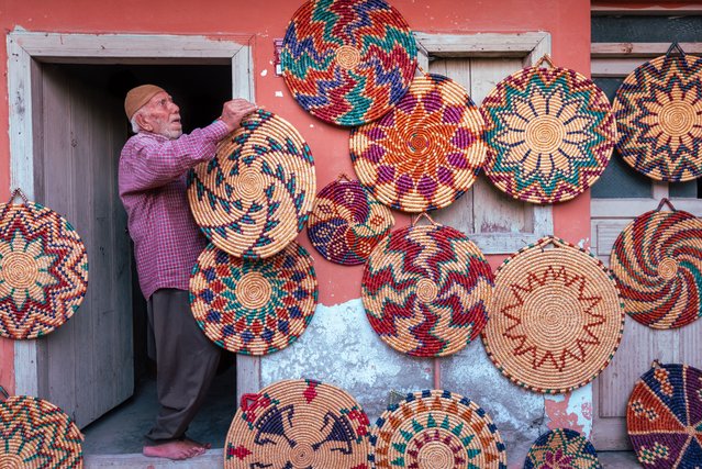 90 years old Niyazi Koleoglu weaves wicker from wheat stalks for 65 years in Altinkaya village in Hatay's Altinozu district, Turkiye on August 16, 2024. Koleoglu, who continues to weave wicker despite his advanced age, colors the wheat stalks collected from the fields at harvest time with the help of root dye. The colored and dried wheat stalks turn into art in his hands. (Photo by Meric Aktar/Anadolu via Getty Images)