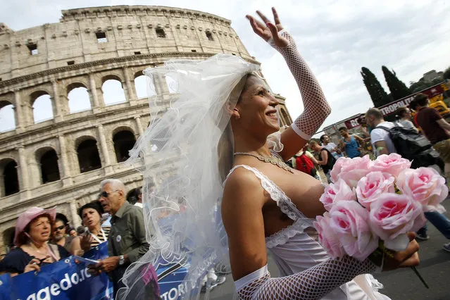 People march past the Colosseum during the Gay Pride parade in Rome, Saturday, June 11, 2016. (Photo by Fabio Frustaci/AP Photo)
