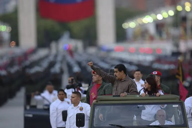 Venezuela's President Nicolas Maduro (2nd R) gestures next to his wife Cilia Flores, during the 78th anniversary ceremony of the Venezuelan National Guard in Caracas, Venezuela, in this handout picture provided by Miraflores Palace August 4, 2015. (Photo by Miraflores Palace/Reuters)