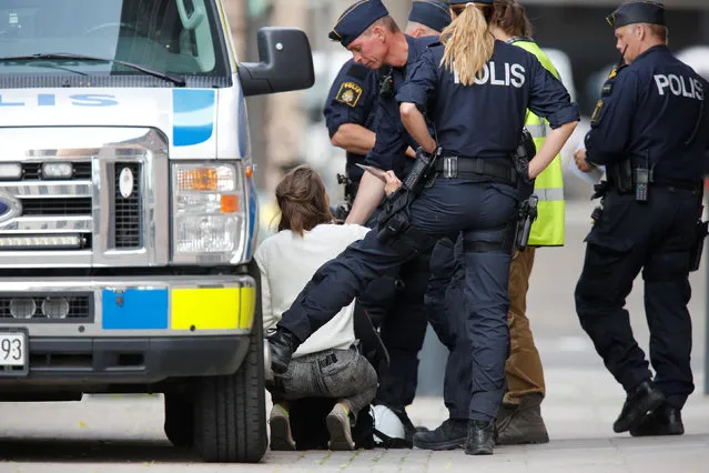 A person is arrested by police officers after environmental activists entered the prime minister's office building in central Stockholm June 15, 2016. (Photo by Christine Olssom/Reuters/TT News Agency)