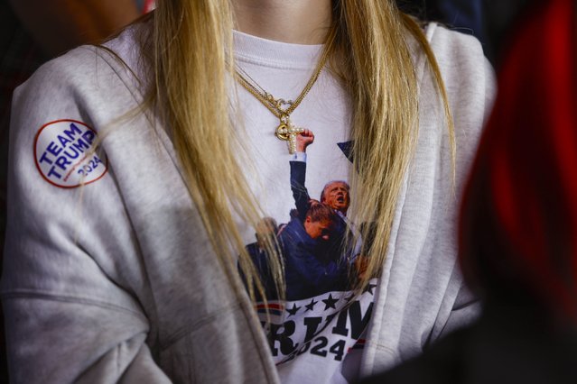 A woman's shirt with a cross as she listens to former president and current Republican presidential nominee Donald Trump speak at a campaign rally at the Dodge County Airport in Juneau, Wisconsin, USA, 06 October 2024. (Photo by Jeffrey Phelps/EPA/EFE)