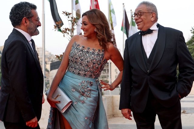 This handout picture released by the Amman International Film Festival (AIFF) shows Lebanese actor Georges Khabbaz (L), Egyptian actress Bushra Rozza (C), and film director Yousry Nasrallah posing on the red carpet of the 3rd edition of the AIFF on August 15, 2023. (Photo by Patrick Baz/Amman International Film Festival (AIFF) via AFP Photo)