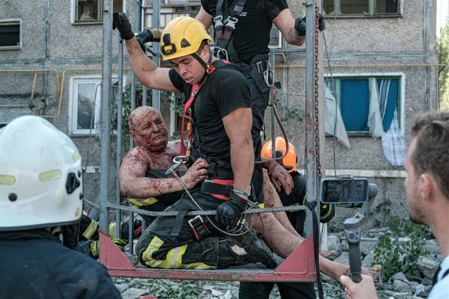 Ukrainian rescue workers evacuate a wounded person after shelling at a residential area in Mykolaiv, southern Ukraine, 29 June 2022. The Head of the Mykolaiv Regional Military Administration, Vitaliy Kim, reported that as a result of shelling hitting a high-rise apartment building in Mykolaiv on 29 June 2022, at least three people died and five others were injured. Russian troops on 24 February entered Ukrainian territory, starting a conflict that has provoked destruction and a humanitarian crisis. (Photo by George Ivanchenko/EPA/EFE/Rex Features/Shutterstock)