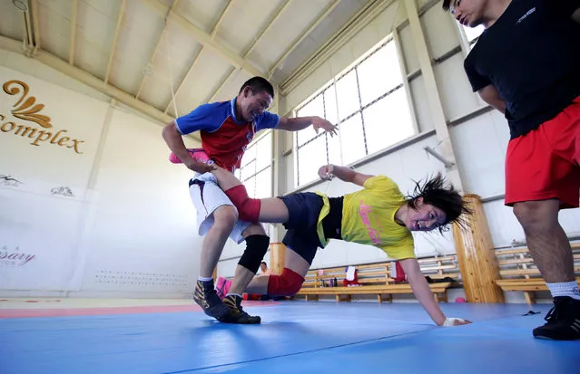Mongolia's Olympic wrestler Battsetseg Soronzonbold (C) fights with her training partner during a daily training session at the Mongolia Women’s National Wrestling Team training centre in Bayanzurkh district of Ulaanbaatar, Mongolia, July 1, 2016. (Photo by Jason Lee/Reuters)