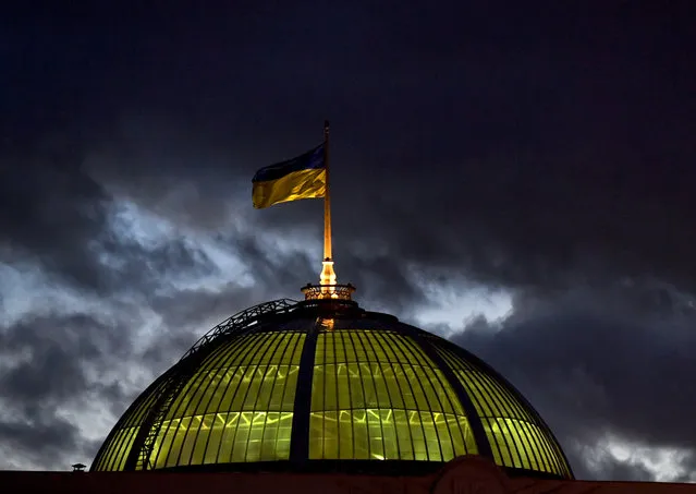 A Ukrainian flag flies in the wind at the top of the parliament in Kiev on February 3, 2020. (Photo by Sergei Supinsky/AFP Photo)
