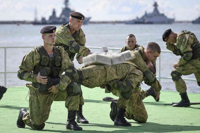 Russian marines show their skills during a rehearsal for the Naval parade in Baltiysk, a Navy base in Russian Baltic Sea exclave, Russia, Thursday, July 28, 2022 (Photo by AP Photo/Stringer)