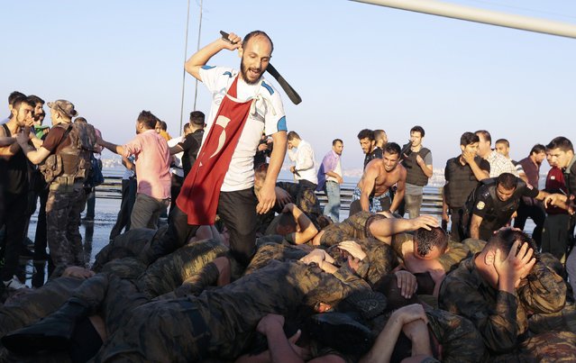 Surrendered Turkish soldiers who were involved in the coup are beaten by a civilian on Bosphorus bridge in Istanbul, Turkey, July 16, 2016. (Photo by Reuters/Stringer)
