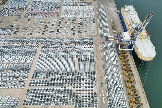 This aerial photo taken on August 7, 2022 shows newly-produced vehicles to be exported at a port in Yantai in China's eastern Shandong province. (Photo by AFP Photo/China Stringer Network)
