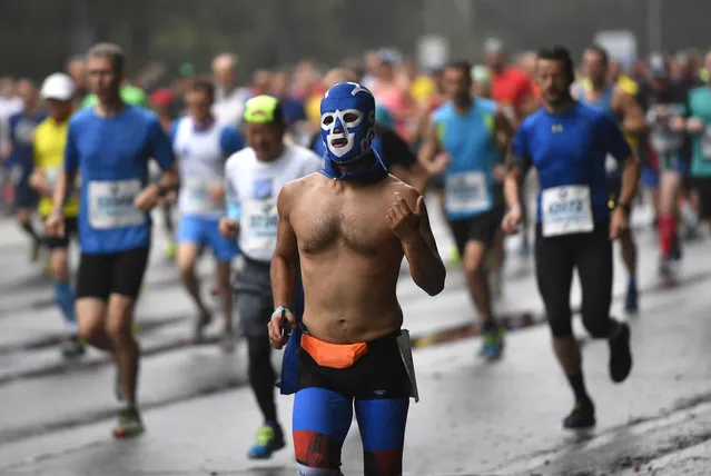 A masked man participates in the 44th Berlin marathon in Berlin, Germany, Sunday, September 24, 2017. (Photo by Martin Meissner/AP Photo)