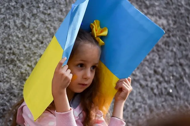 A girl looks on as protesters demonstrate against Russia's invasion of Ukraine, during a Ukrainian Independence Day rally, in Dublin, Ireland on August 24, 2022. (Photo by Clodagh Kilcoyne /Reuters)