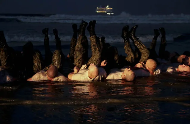 This Monday May 4, 2020, photo provided by the U.S. Navy shows SEAL candidates participating in “surf immersion” during Basic Underwater Demolition/SEAL (BUD/S) training at Naval Special Warfare (NSW) Center in Coronado, Calif. Navy SEAL recruits and their instructors are being tested for the coronavirus as the candidates in one of the military's most grueling programs return to training with new social distancing guidelines, a top official said Tuesday, May 5, 2020. (Photo by MC1 Anthony Walker/U.S. Navy via AP Photo)