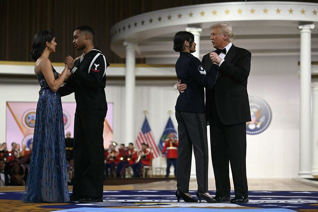 US President Donald Trump (R) Usha Vance (L) dance with members of the armed forces to The Battle Hymn of the Republic during the Commander-In-Chief inaugural ball at the Walter E. Washington Convention Center in Washington, DC, on January 20, 2025. (Photo by Jim Watson/AFP Photo)