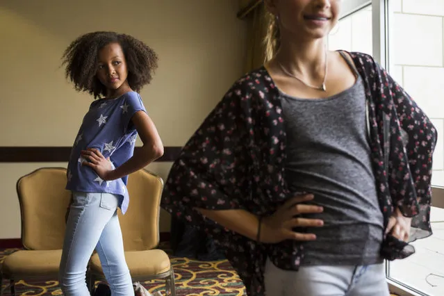 Aicha Bleers, 11, of Chevy Chase, Md., practices her runway posing at a modeling camp at the Courtyard Marriott Hotel in McLean, Va., on Tuesday, August 18th, 2015. (Photo by Brittany Greeson/The Washington Post)