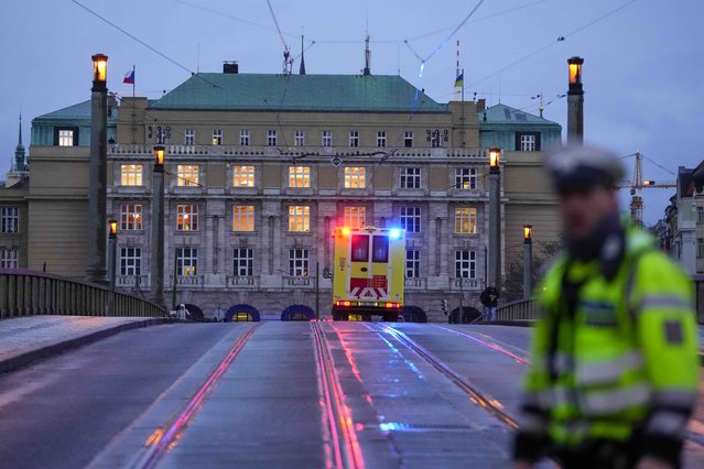 An ambulance drives towards the building of Philosophical Faculty of Charles University in downtown Prague, Czech Republic, Thursday, December 21, 2023. Czech police say a shooting in downtown Prague has killed an unspecified number of people and wounded others. (Phoot by Petr David Josek/AP Photo)