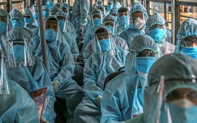 Indian healthcare workers and volunteers of Rashtriya Swayamsevak Sangh (RSS) wearing personal protective equipment (PPE) arrive to conduct medical check-up on residents at Ramabai Ambedkar Nagar, in Mumbai, India, 17 June 2020. According to media reports, the number of confirmed cases of coronavirus in India rose to more than 354,000 and more than 11,000 people deaths. (Photo by Divyakant Solanki/EPA/EFE)