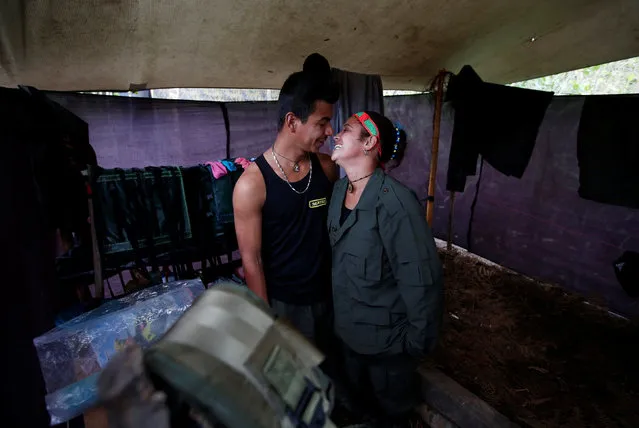 Yeimi and Sebastian, members of the 51st Front of the Revolutionary Armed Forces of Colombia (FARC), are seen inside a tent at a camp in Cordillera Oriental, Colombia, August 16, 2016. (Photo by John Vizcaino/Reuters)