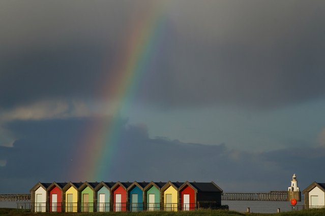 A rainbow appears over the beach huts at Blyth in Northumberland, UK on Tuesday, September 27, 2022. (Photo by Owen Humphreys/PA Images via Getty Images)