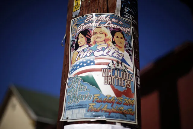 A flyer for a concert named “English as a Second Language”, of Latino artists singing in Spanish and English, is seen in the Boyle Heights area of Los Angeles, home to many Mexican migrants, in California August 5, 2014. (Photo by Lucy Nicholson/Reuters)