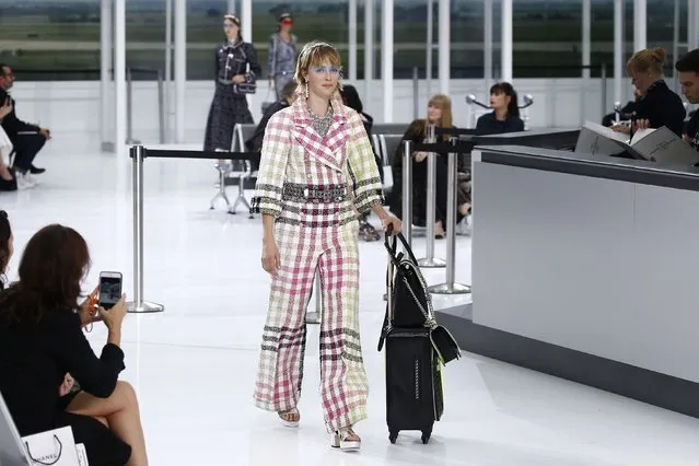 Bitish model Edie Campbell presents a creation by German designer Karl Lagerfeld as part of his Spring/Summer 2016 women's ready-to-wear collection for fashion house Chanel at the Grand Palais which is transformed into a Chanel airport during Fashion Week in Paris, France, October 6, 2015. (Photo by Benoit Tessier/Reuters)