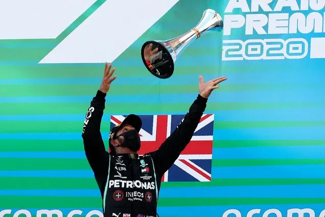 Mercedes driver Lewis Hamilton of Britain throws his trophy after the Formula One Grand Prix at the Barcelona Catalunya racetrack in Montmelo, Spain, Sunday, August 16, 2020. (Photo by Albert Gea/Pool via AP Photo)