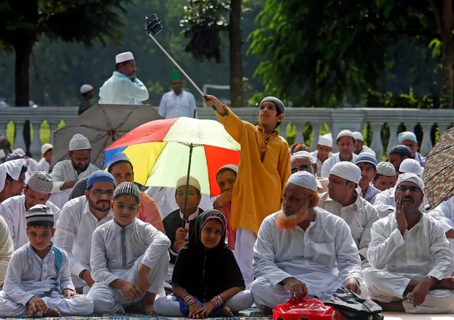 A boy uses a selfie stick to take a photograph before offering Eid al-Adha prayers on a road in Kolkata, India September 13, 2016. (Photo by Rupak De Chowdhuri/Reuters)