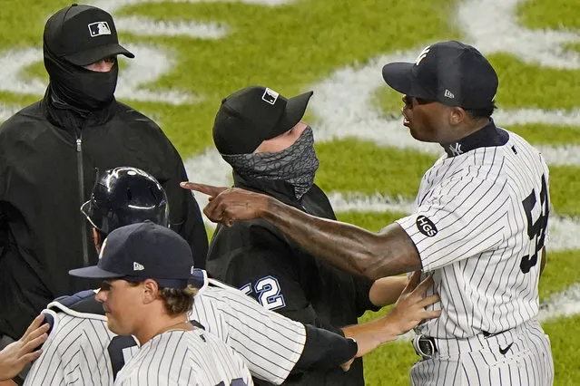 Third base umpire Jansen Visconti, center, restrains New York Yankees relief pitcher Aroldis Chapman, right, after the Tampa Bay Rays and Yankees traded words after the Yankees' 5-3 victory in a baseball game, Tuesday, September 1, 2020, at Yankee Stadium in New York. The altercation ensued after Chapman threw a high pitch at Rays pinch hitter Michael Brosseau in the final at-bat of the game. (Photo by Kathy Willens/AP Photo)
