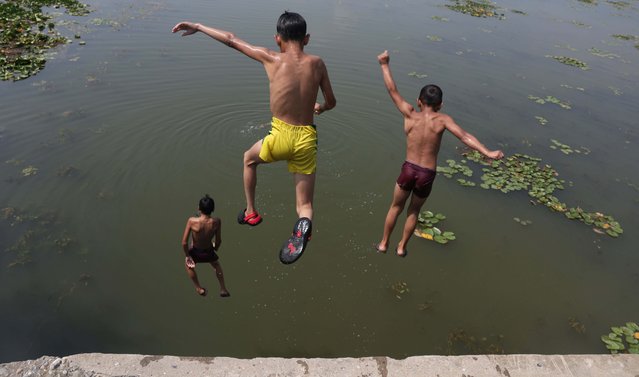 Boys jump into the water of Dal Lake to beat the heat on a hot day in the outskirts of Srinagar, the summer capital of Indian Kashmir, 20 June 2025. Kashmir witnessed an unprecedented heatwave. On 19 June 2025, Srinagar recorded the highest-ever June temperatures in 20 years. (Photo by Farooq Khan/EPA/EFE)