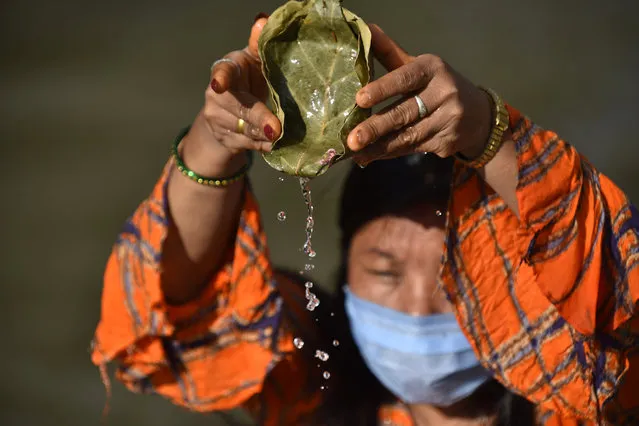 A Nepalese devotee offers ritual prayer at the Bank of Bagmati River of Pashupatinath Temple during Rishi Panchami Festival celebrations at Kathmandu, Nepal on Sunday, August 23, 2020. Rishi Panchami festival is  celebrated as the last day of three-day long Teej Festival. The Teej festival is celebrated by Hindu women in Nepal as well as in some parts of India. During the three-day long festival, women observe a day-long fast and pray for the long life of their husbands as well as for a happy family. Those who are unmarried pray for a good husband and a long life. Due to prohibitory order lockdown in Kathmandu valley for a week-long, as rapid increase in the number of COVID-19 cases. (Photo by Narayan Maharjan/NurPhoto via Getty Images)