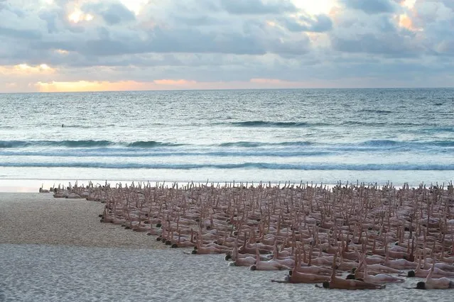 Members of the public pose at sunrise for photographic artist Spencer Tunick at Bondi Beach on November 26, 2022 in Sydney, Australia. US artist and photographer Spencer Tunick created the nude installation using thousands of volunteers posing at sunrise on Bondi Beach, commissioned by charity Skin Check Champions to raise awareness of skin cancer and to coincide with National Skin Cancer Action Week. (Photo by Lisa Maree Williams/Getty Images)