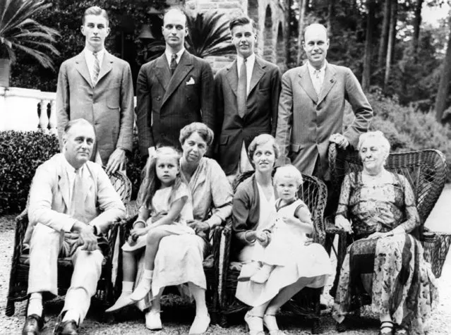 Gov. Franklin D. Roosevelt, seated at left, is seen with his family, July 11, 1932. Seated, left to right: the governor, his wife Eleanor holding their granddaughter Anna; their daughter Anna Roosevelt Dall holding son Curtis Dall, Jr.; and the governor's mother Sara Delano Roosevelt.  Standing, from left to right:  Gov. Roosevelt's sons Franklin Jr., James, and John Roosevelt, and son-in-law Curtis Dall. (Photo by AP Photo)