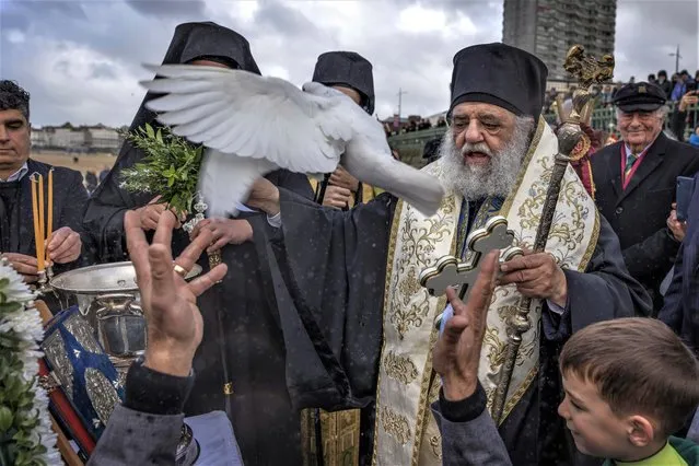 A dove is released during the “Blessing of the Seas” ceremony on January 08, 2023 in Margate, England. With its large community of Greek Cypriot residents, the Kent coastal town of Margate became the setting for a Blessing of the Seas procession and ceremony in the 1960s. The Greek Orthodox church celebrates Epiphany marking the baptism of Jesus Christ. Celebrations return in full this year having been curtailed during the Covid Pandemic in 2021/2022. (Photo by Dan Kitwood/Getty Images)